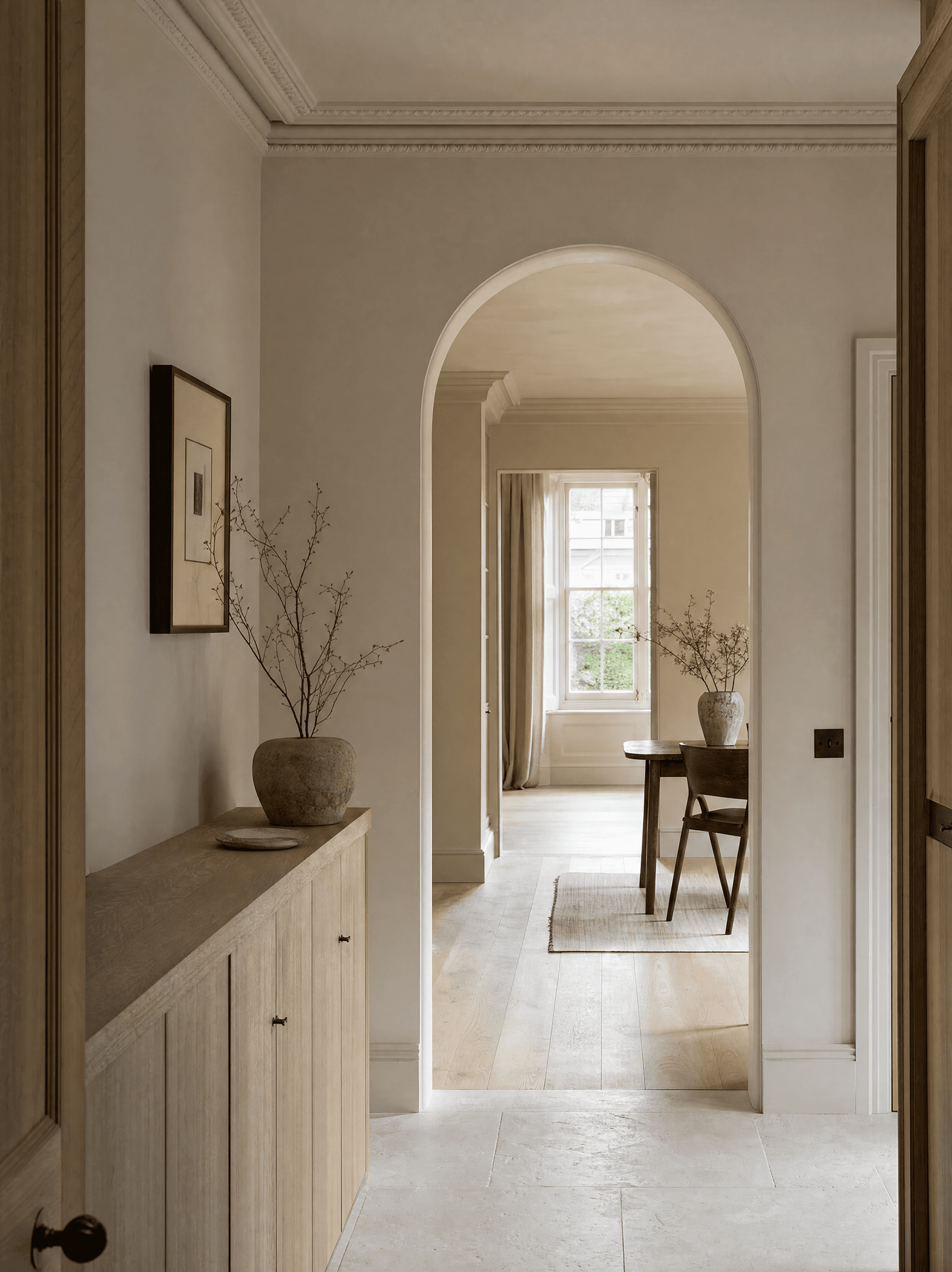 Light-filled hallway with an arched doorway leading to a dining room
