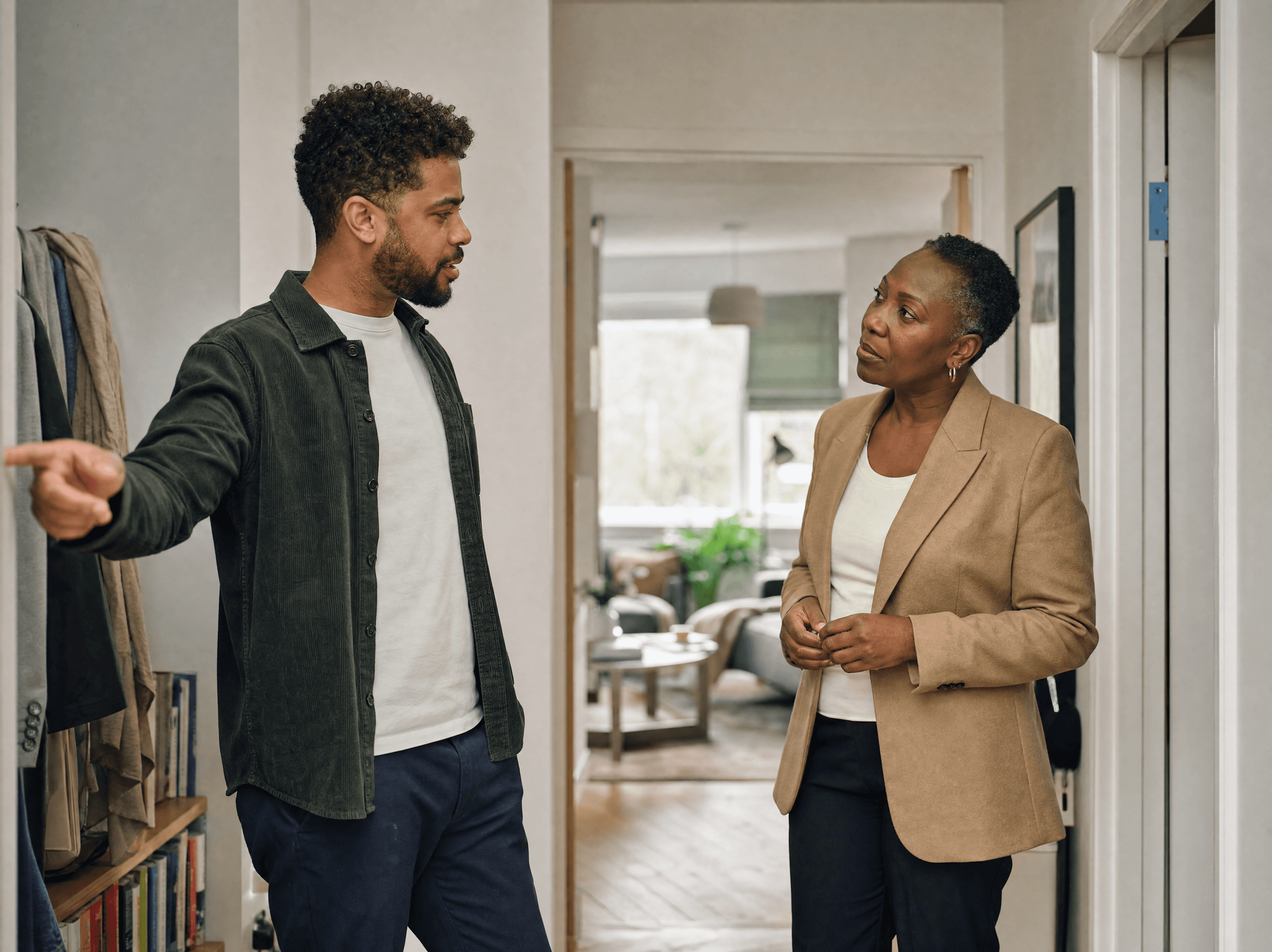 Letting agent talking with a tenant in the hallway of her apartment